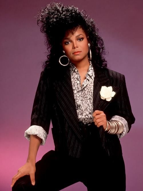Janet Jackson posing in a blazer 