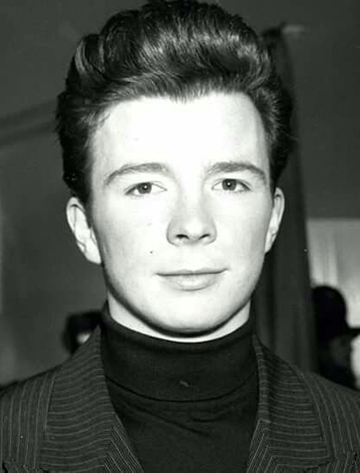 A black and white photo of Astley in the 80s