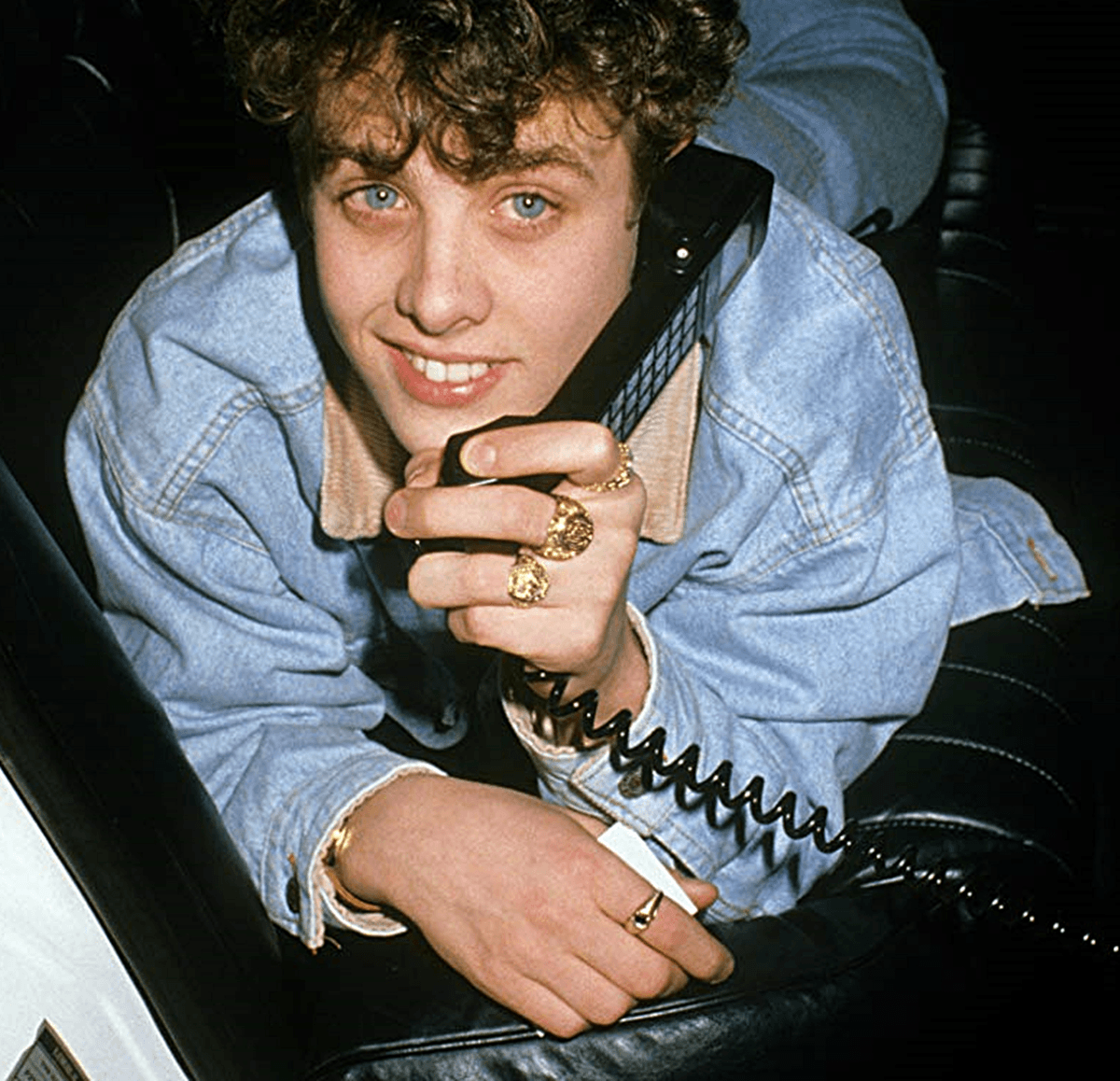 1990s Joey McIntyre in limo using car phone, wearing gold rings
